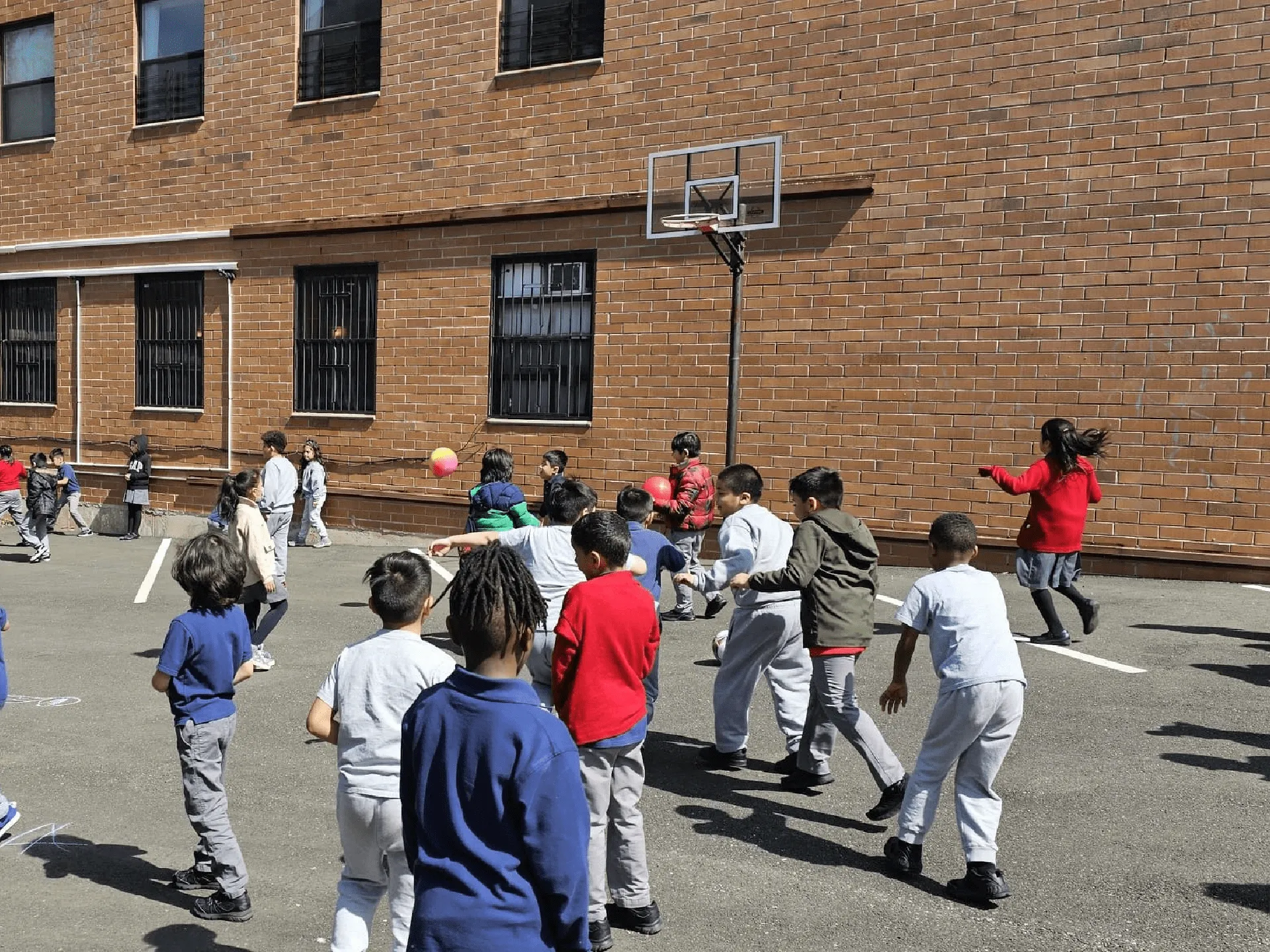 A children playing in basket ball area